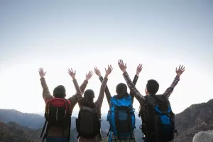 Four Hikers With Arms In The Air C