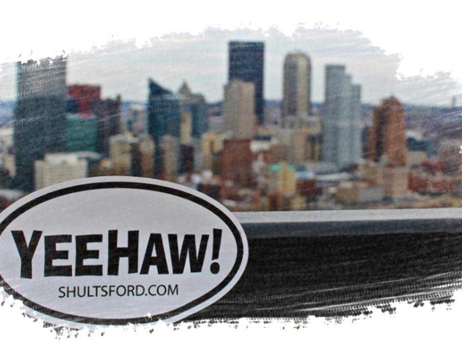 City skyline with YEEHAW! logo