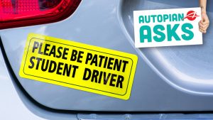 Please Be Patient Student Driver Yellow Bumper Sticker On The Car.