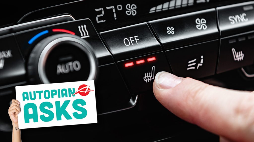 Hand Pressing The Button For Heated Seats In The Car