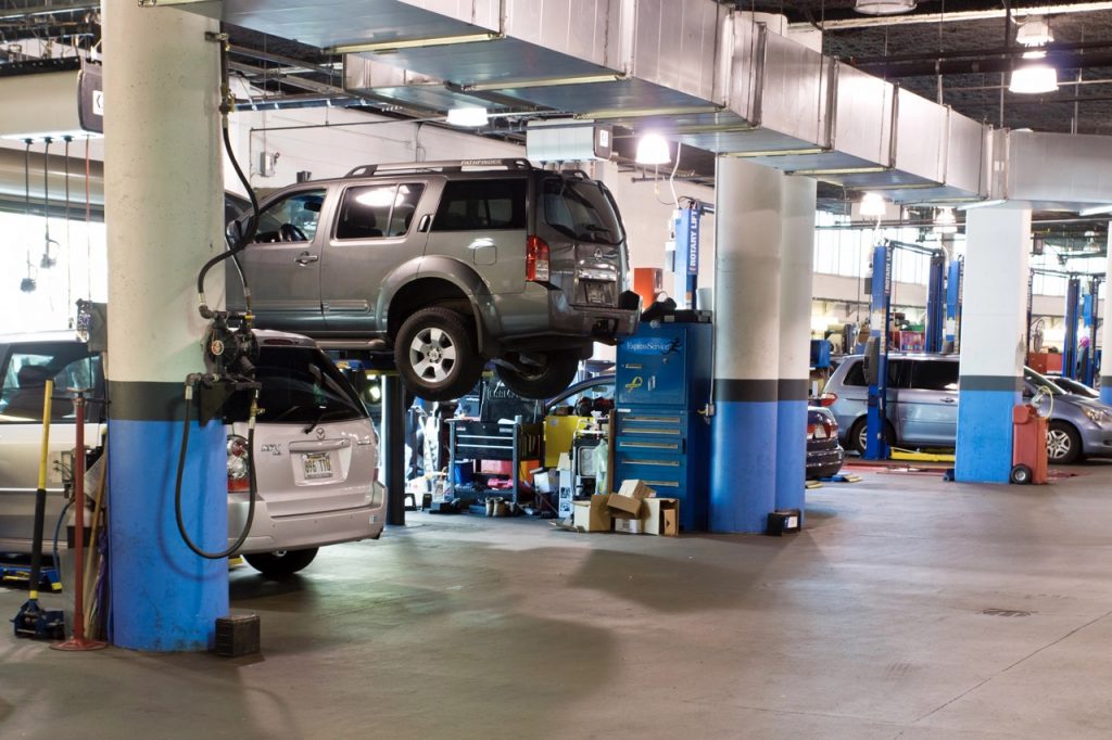 Cars Being Repaired In A Mechanic Shop.