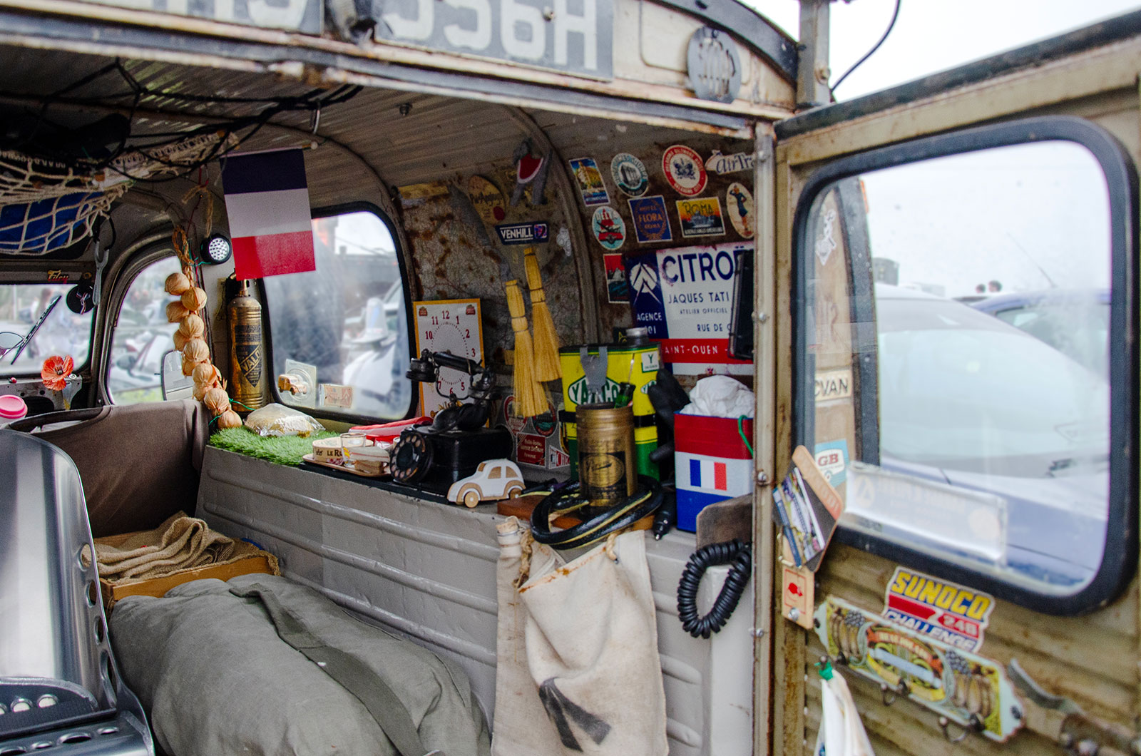 The interior of a Citroen AK350, showing lots of memorabilia