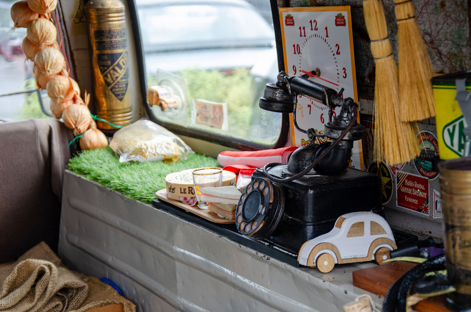 The interior of a Citroen AK350, showing lots of memorabilia