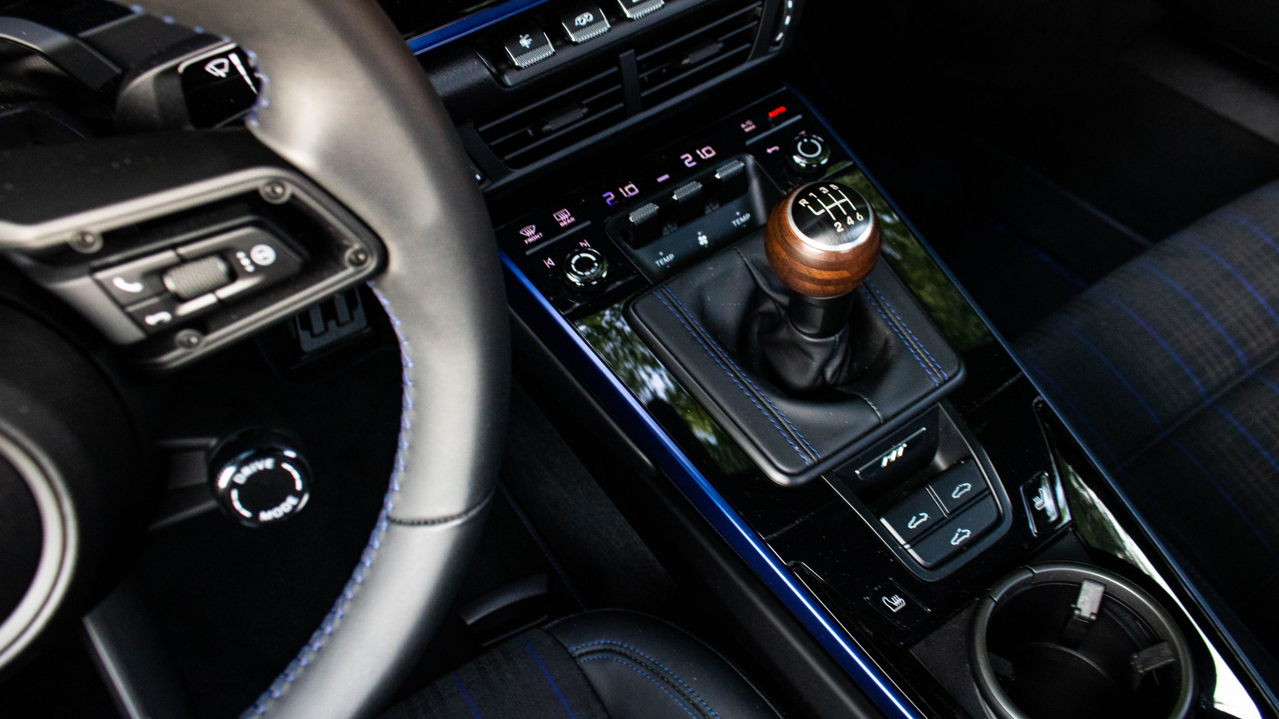 Wood is good. Just keep in mind that if you park in the sun, the top of the knob is metal.