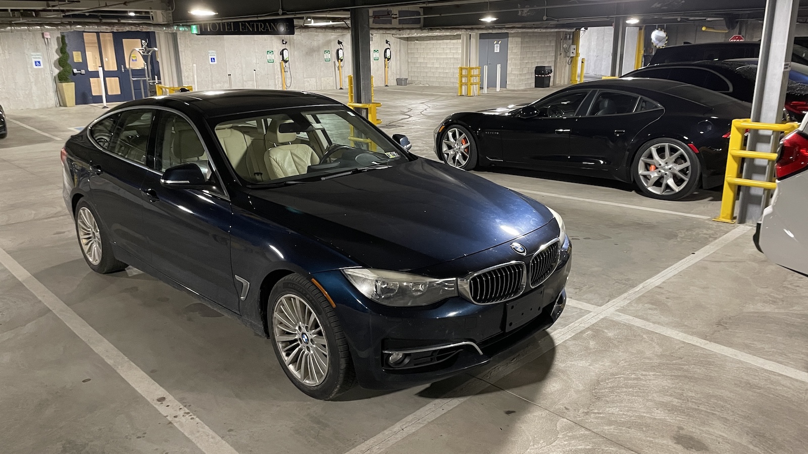 BMW 3 Series GT and Karma Revero in parking garage
