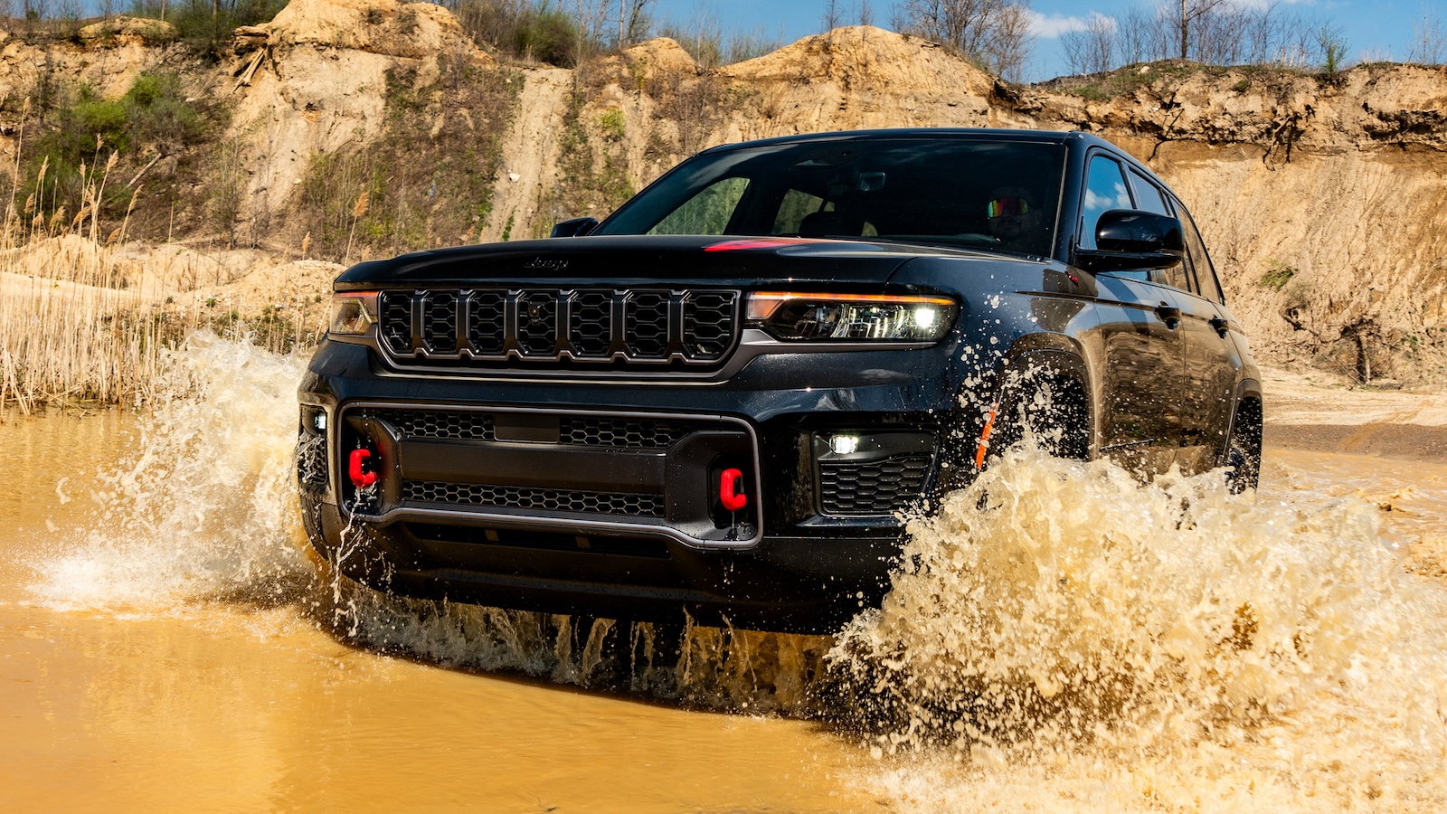 The 2027 Jeep® Grand Cherokee Trailhawk Fording Through Water.