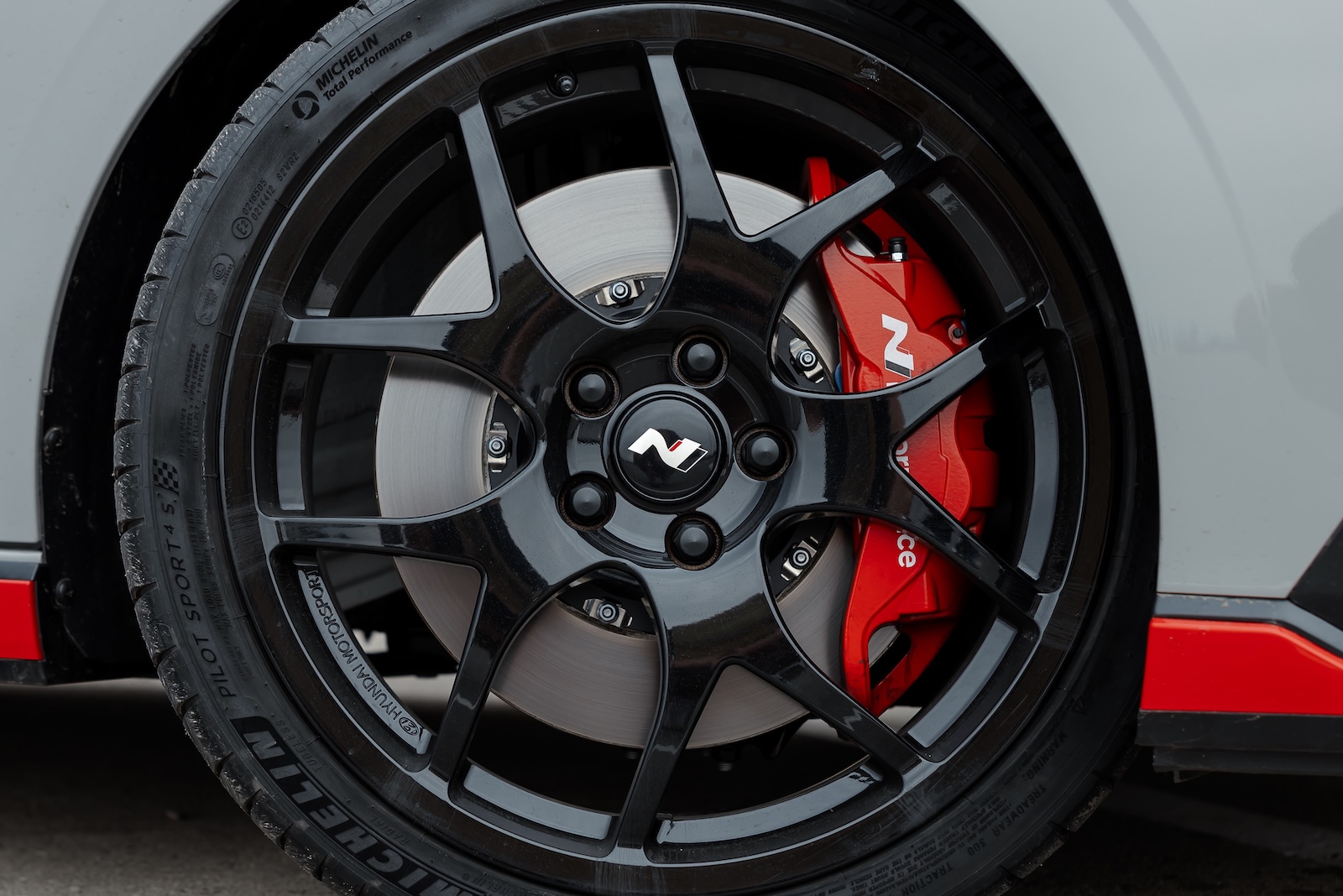 four-piston front calipers, two-piece front discs, and y-spoke wheels