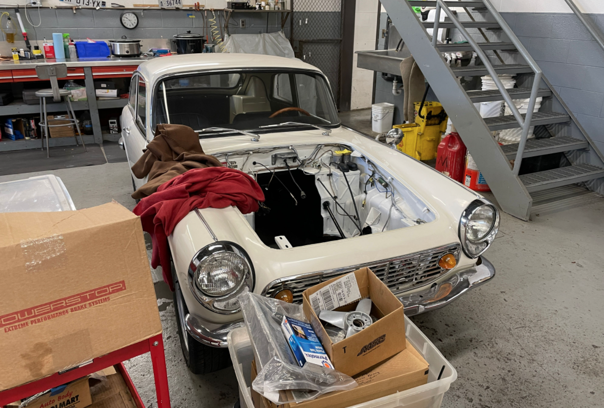 A Honda S600 coupe in the museum workshop, sans engine