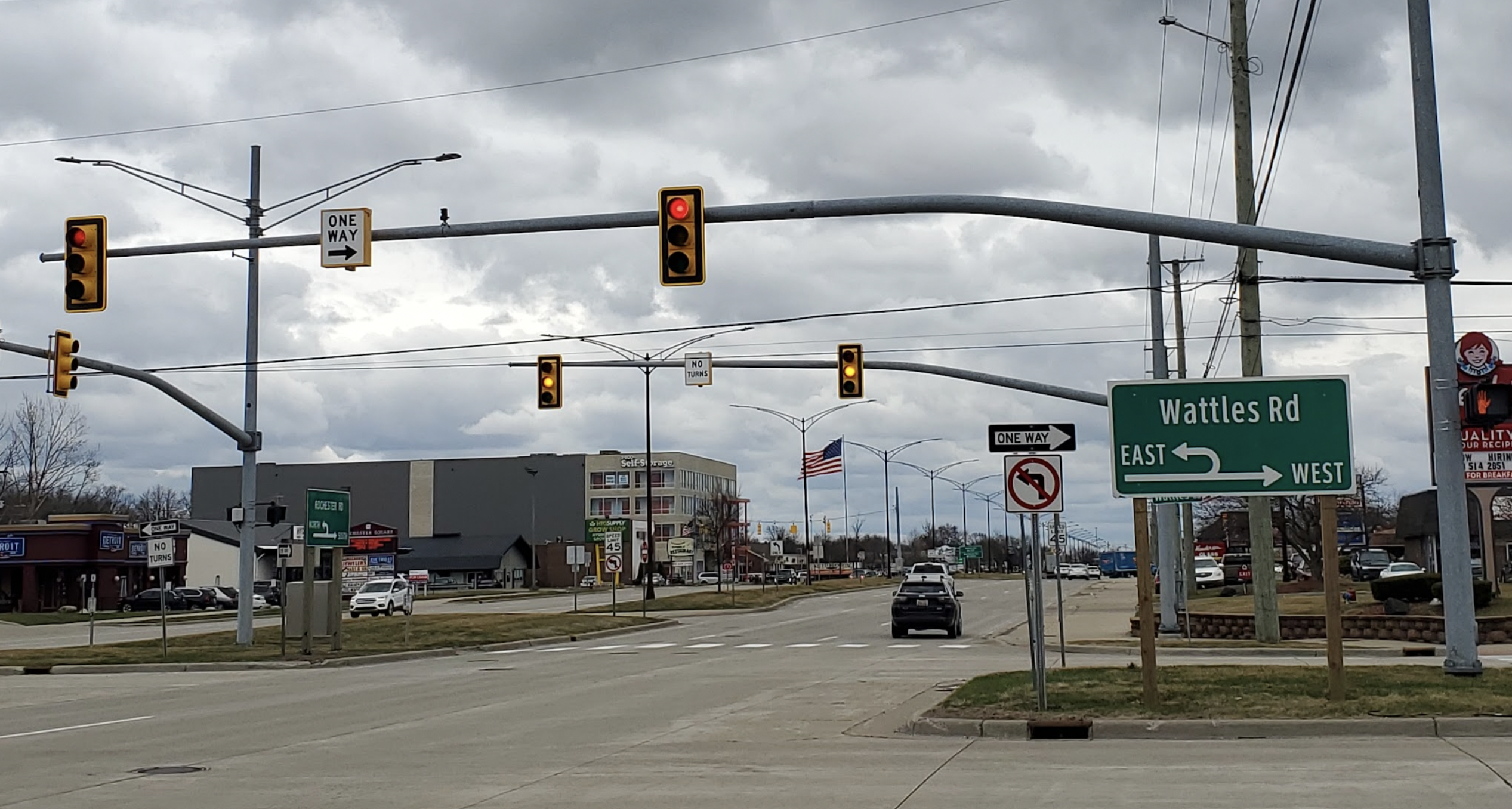 Traffic lights hanging vertically from a pole