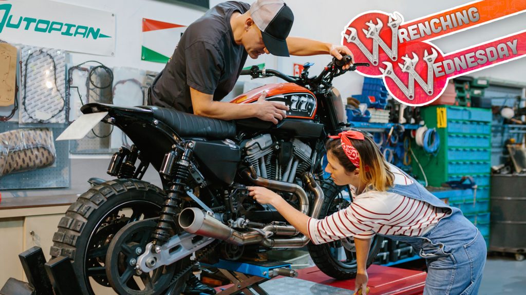 Mechanic Team Reviewing Engine Of Motorbike On Factory